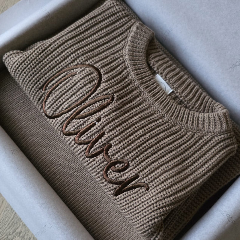 Personalised taupe chunky knit baby sweater embroidered with the name Oliver in matching neutral thread, beautifully folded in a gift box with matching personalised blanket. Soft cotton knit baby jumper & blanket by Little Raine Drops, designed as a timeless keepsake, baby gift or baby shower