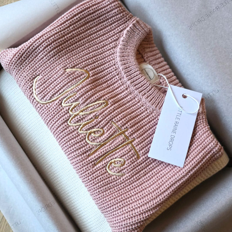 Personalised dusky pink chunky cotton knit baby sweater with embroidered name, with pearl personalised cotton knit blanket, styled in Little Raine Drops gift packaging. A timeless newborn and baby shower keepsake