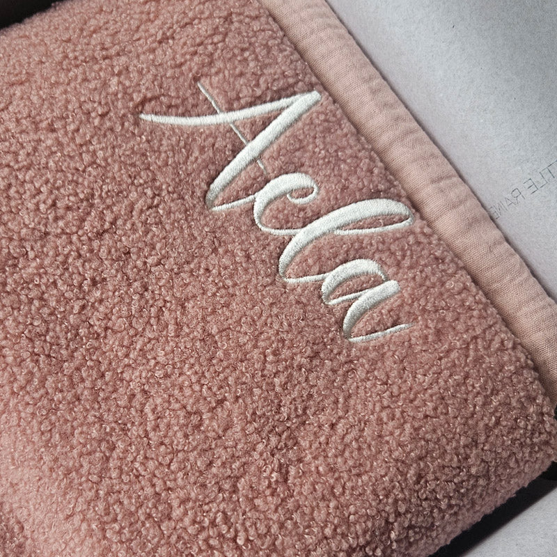 Dusky Pink boucle personalised baby blanket, folded and packaged. Personalised with the name Aela by little Raine Drops Ireland for beautiful soft keepsake, gift, baby shower gift