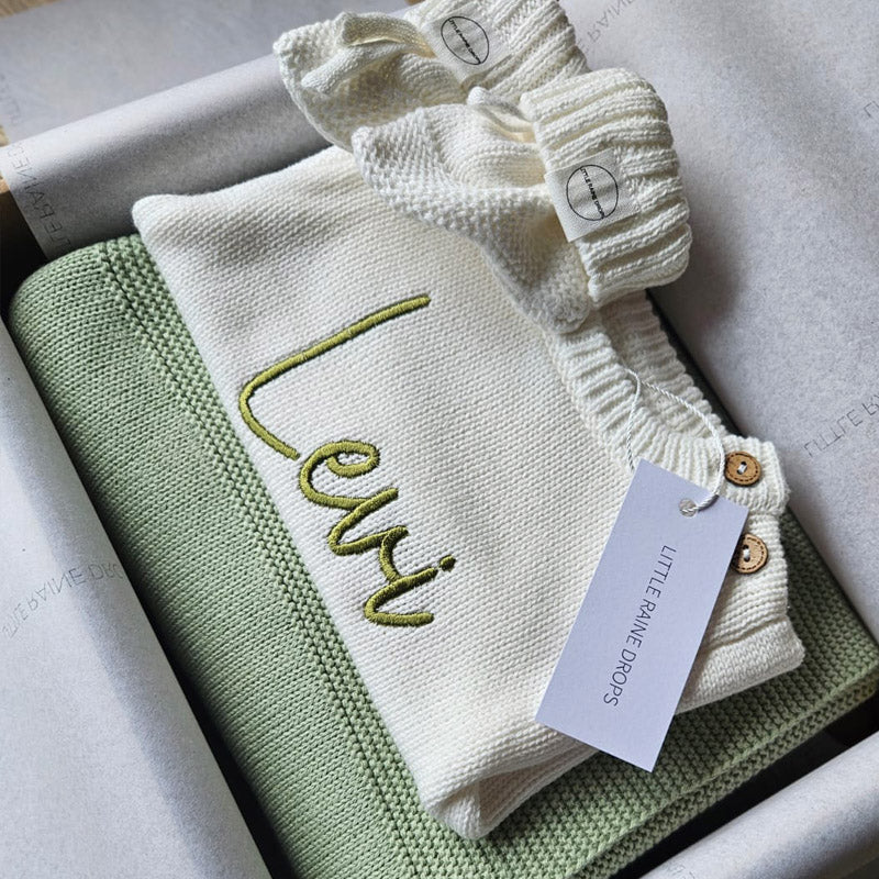 Personalised Pearl cotton knit baby romper and booties announcement set with personalised green cotton knit blanket. Folded, packaged and ready for gifting, baby shower or memorable baby keepsake by Little Raine Drops Ireland