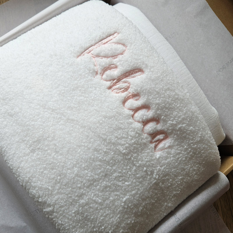 White triple layer boucle personalised baby blanket, folded and packaged. Personalised with the name Rebecca by little Raine Drops Ireland for beautiful soft keepsake, gift, baby shower gift