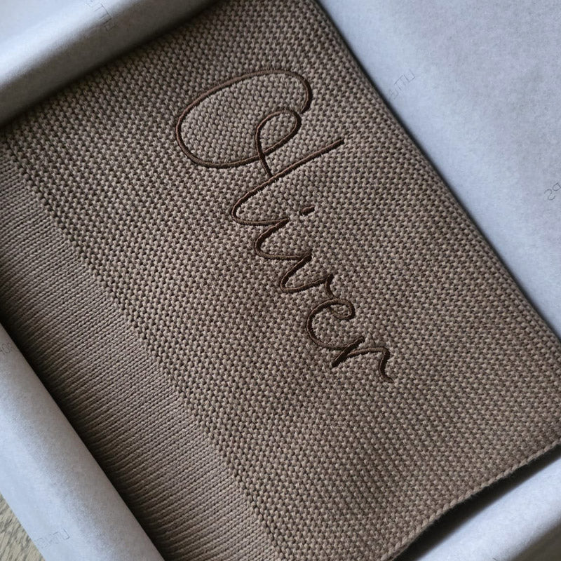 Taupe cotton knit blanket personalised with the name Oliver. Packaged for gifting by Little Raine Drops Ireland