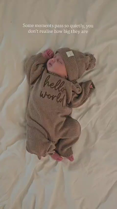 video of sleeping baby wearing Little Raine Drops personalised cotton knit long leg romper with matching hat on white background
