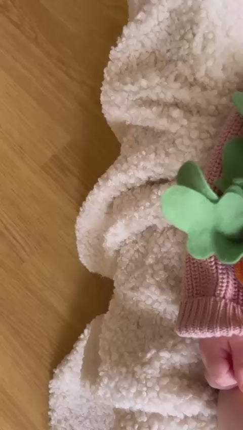 Baby lying asleep wearing a little raine drops dusky pink chunky knit sweater personalised with "somebunny loves you", with matching chunky knit shorts and beanie bunny. perfect spring, easter cosy outfit or gift